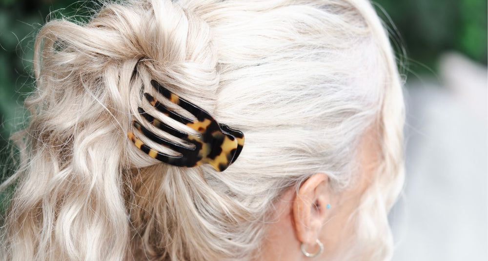 Silver grey hair twisted up with a TEGEN claw clip