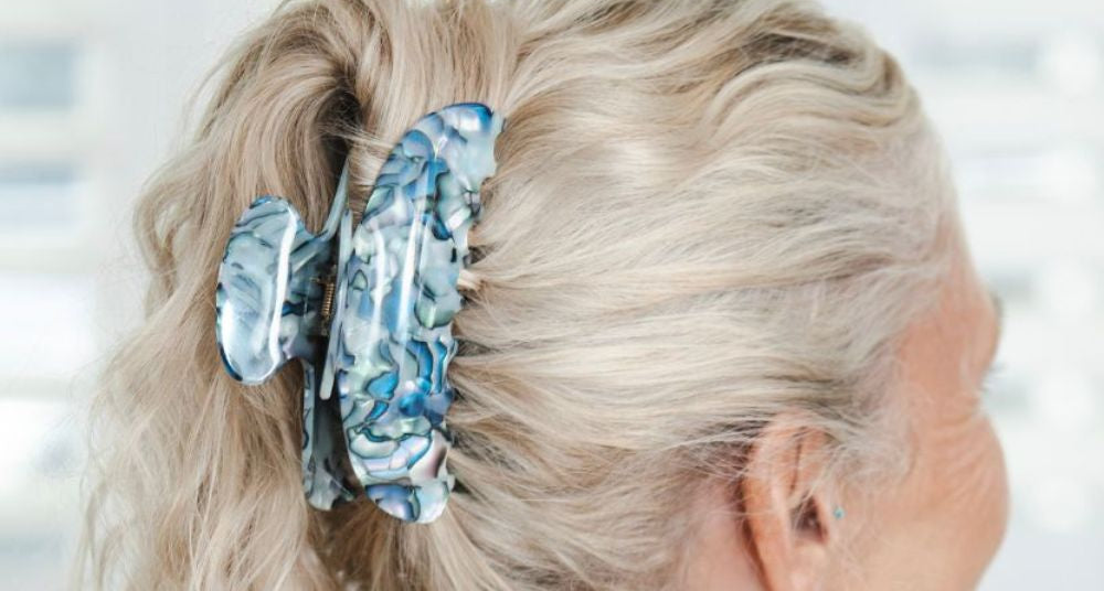 Long grey hair held up with a TEGEN claw clip